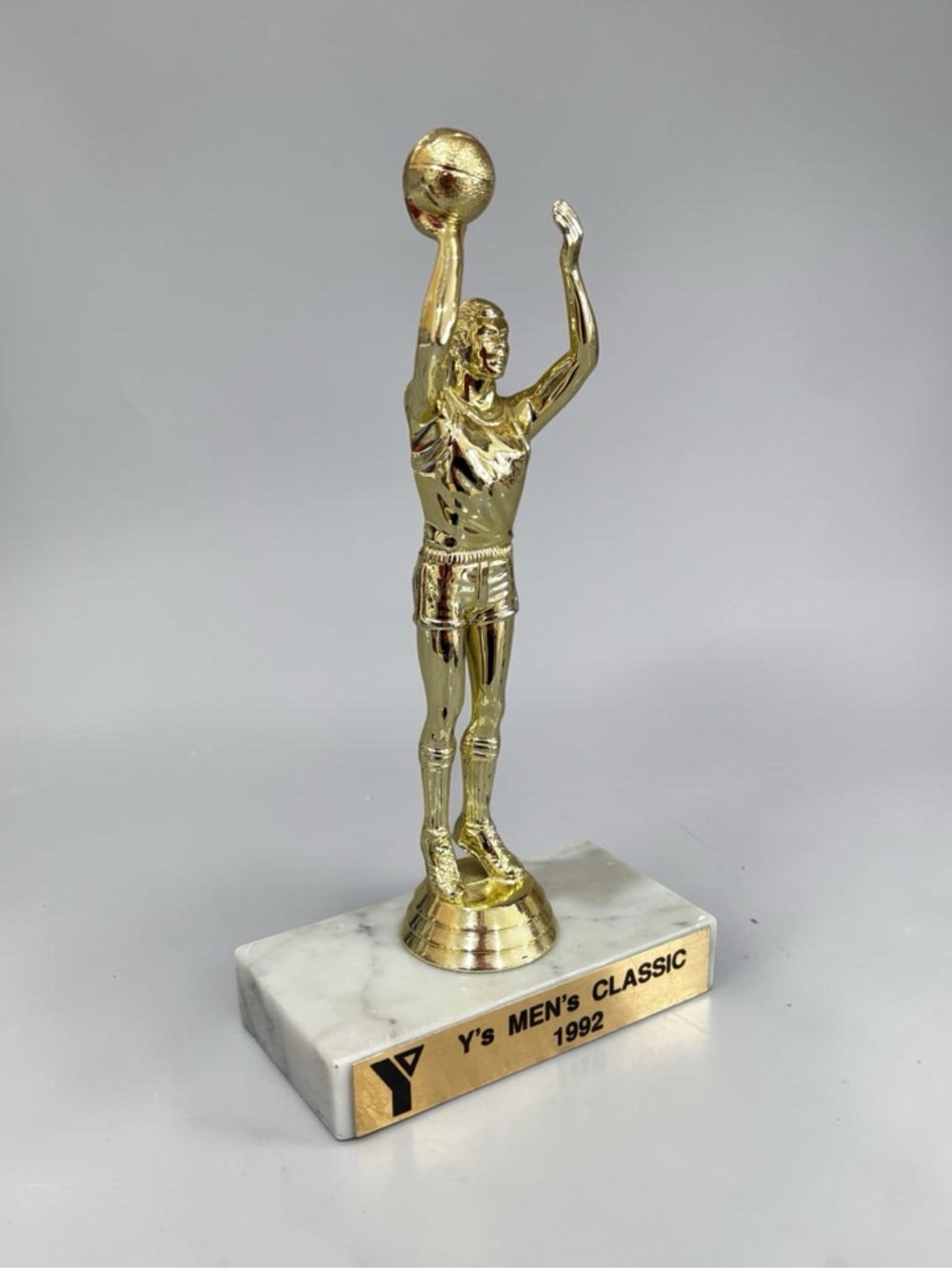 Gold Basketball Player Award Trophy on White Marble Base